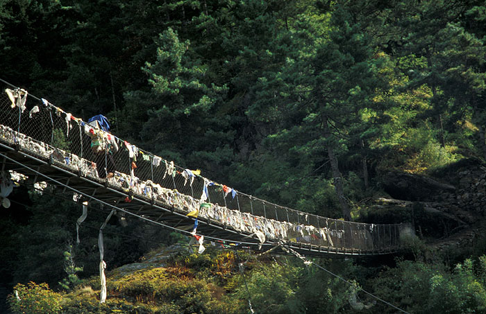 Larja Bridge (2830m) - The bridge hovers above a canyon at the meeting of the Dudh Koshi River and the Bhote Koshi River and marks the beginning of the arduous climbing up 610m of altitude to Namche Bazaar (3440m)
<br>
Photo: Robert Downie - 2004 (EOS 300)