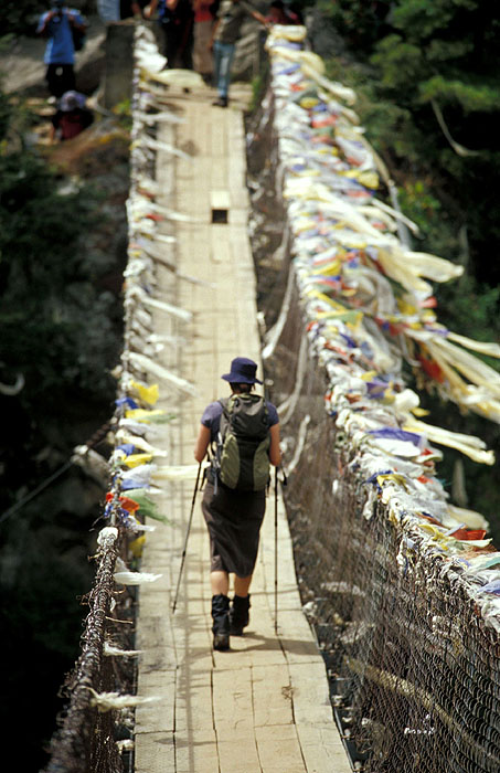 Ady crossing the Larja Bridge (2830m) - The bridge hovers above a canyon at the meeting of the Dudh Koshi River and the Bhote Koshi River and marks the beginning of the arduous afternoon climbing up 610m of altitude to Namche Bazaar (3440m)
<br>
Photo: Robert Downie - 2004 (EOS 300)