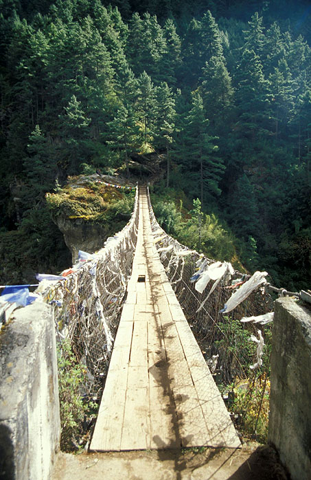 Larja Bridge (2830m) - The bridge hovers above a canyon at the meeting of the Dudh Koshi River and the Bhote Koshi River and marks the beginning of the arduous climbing up 610m of altitude to Namche Bazaar (3440m)
<br>
Photo: Robert Downie - 2004 (EOS 300)
