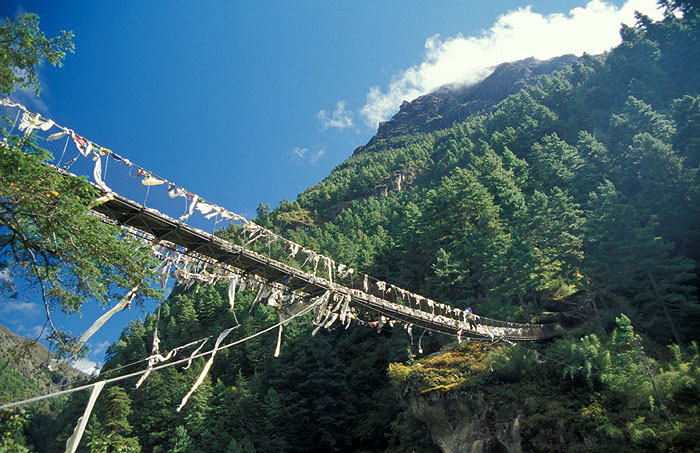 Larja Bridge (2830m) - The bridge hovers above a canyon at the meeting of the Dudh Koshi River and the Bhote Koshi River and marks the beginning of the arduous climbing up 610m of altitude to Namche Bazaar (3440m)
<br>
Photo: Robert Downie - 2004 (EOS 300)