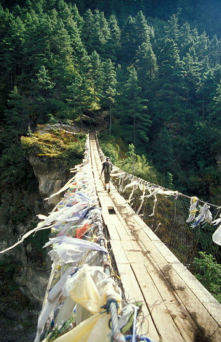Larja Bridge (2830m) - The bridge hovers above a canyon at the meeting of the Dudh Koshi River and the Bhote Koshi River and marks the beginning of the arduous climbing up 610m of altitude to Namche Bazaar (3440m)
<br>
Photo: Robert Downie - 2004 (EOS 300)