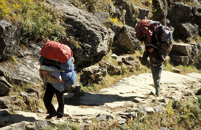 Heavily laden porters moving slowly up the trail.
<br>
Photo: Robert Downie - 2004 (EOS 300)