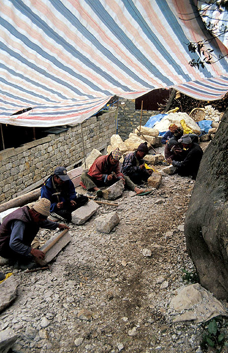 Men chipping rough stones into rectangular bricks for building construction.  Namche Bazaar (3440m) 
<br>
Robert Downie - 2004 (EOS 300)
