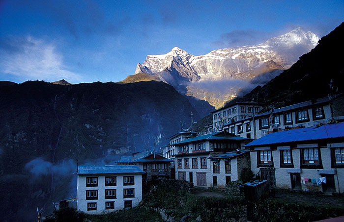 Namche Bazaar (3440m) at dawn with the Kwangde peaks lit up by the first rays of light.
<br>
Robert Downie - 2004 (EOS 300)