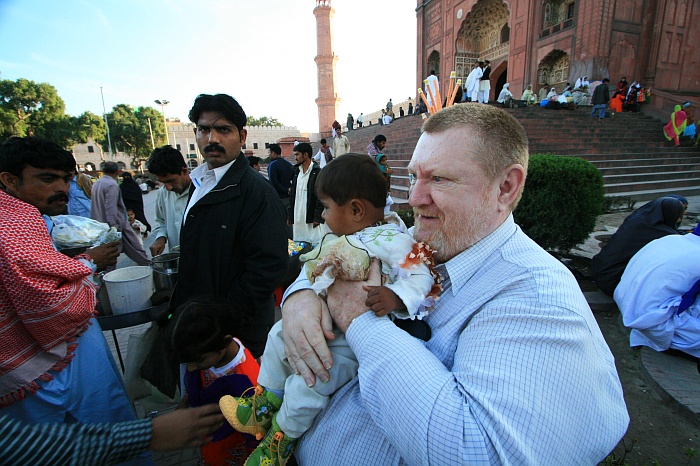 Mick is given a baby for a photo shoot !!
<br>
The courtyard between the Lahore Fort or Shahi Qila and the Badshahi Mosque.  This is the gate of the Badshahi Mosque.
<br>
Photo: Robert Downie - Feb 2007 (EOS 400D)
