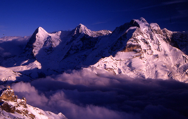 Looking back across towards the Eiger (3970m), M�nch (4099m) and Jungfrau (4158m) from the Schilthorn (2971m)
<br>
You can see the small hut of the cable station at Birg (2676m) in the bottom left
<br>
Photo: Robert Downie - January 2002 (EOS 300) 