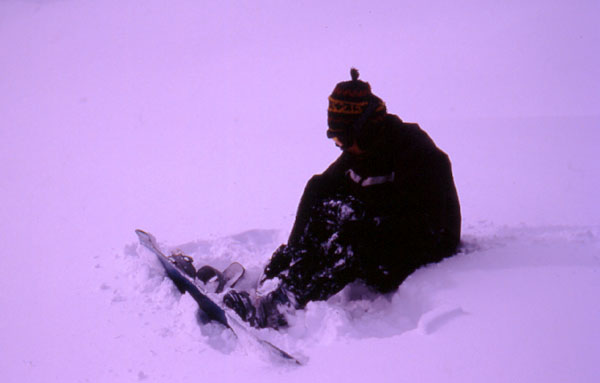 Ady strapping up for another days of hard work out the front of our chalet  - Valbella 
<br>
Photo: Robert Downie - February 2002 (EOS 300) 