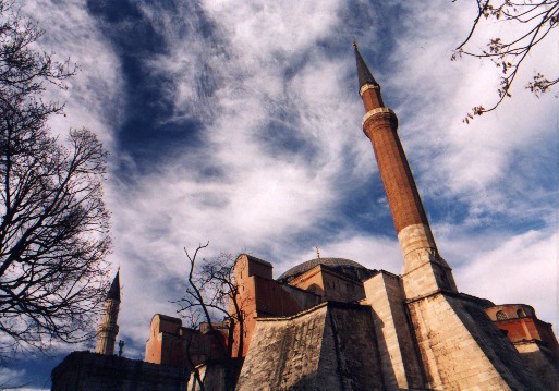 The mighty Aya Sofya, Church of the Divine Wisdom (Hagia Sofia in Greek, Sancta Sophia in Latin).  Construction was initiated by the Byzantine emperor Justinian in 532 AD.  It was superseded by the St Peters's Chapel in Rome almost 1000 years later as the largest house of worship in the world.
<br>
Photo: Robert Downie - January 2001 (EOS 300)
