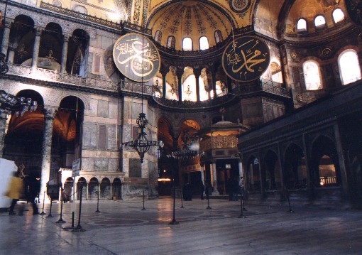 Inside the Aya Sofya, Church of the Divine Wisdom (Hagia Sofia in Greek, Sancta Sophia in Latin).  Construction was initiated by the Byzantine emperor Justinian in 532 AD.  It was superseded by the St Peters's Chapel in Rome almost 1000 years later as the largest house of worship in the world.  The Arabic panels were added when the building was converted into a mosque in 1453.
<br>
Photo: Robert Downie - January 2001 (EOS 300)