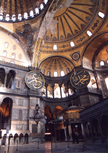 Inside the Aya Sofya, Church of the Divine Wisdom (Hagia Sofia in Greek, Sancta Sophia in Latin).  Construction was initiated by the Byzantine emperor Justinian in 532 AD.  It was superseded by the St Peters's Chapel in Rome almost 1000 years later as the largest house of worship in the world.  The Arabic panels were added when the building was converted into a mosque in 1453.
<br>
Photo: Robert Downie - January 2001 (EOS 300)