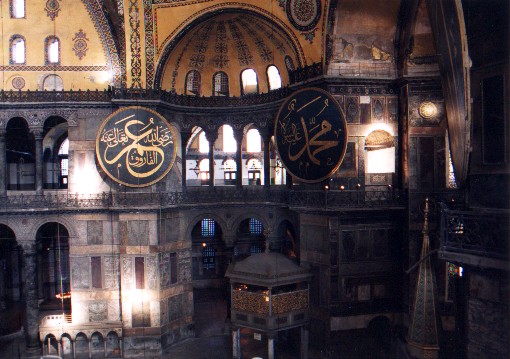 Inside the Aya Sofya, Church of the Divine Wisdom (Hagia Sofia in Greek, Sancta Sophia in Latin).  Construction was initiated by the Byzantine emperor Justinian in 532 AD.  It was superseded by the St Peters's Chapel in Rome almost 1000 years later as the largest house of worship in the world.  The Arabic panels were added when the building was converted into a mosque in 1453.
<br>
Photo: Robert Downie - January 2001 (EOS 300)